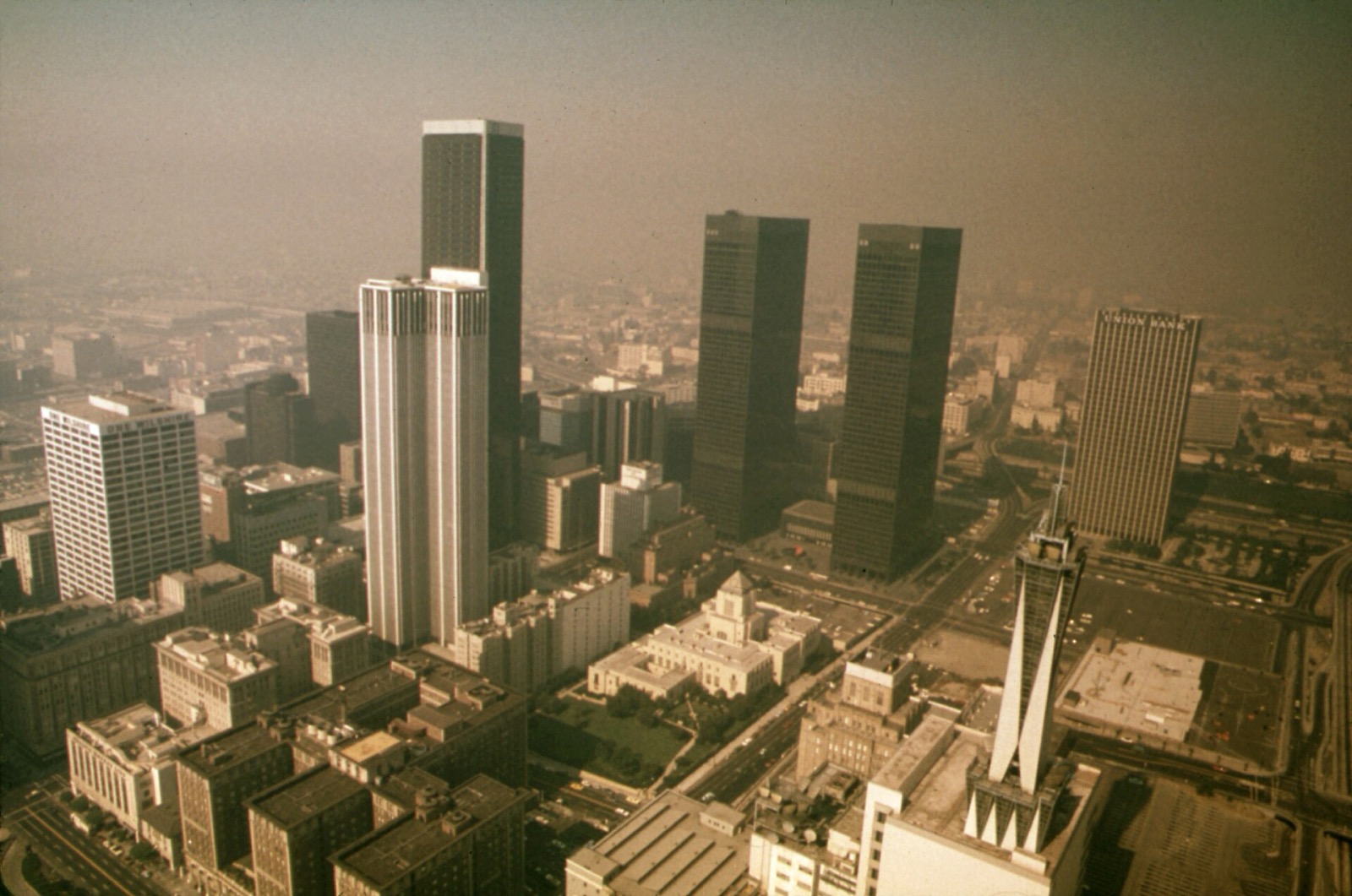 Aerial photograph of downtown Los Angeles in the 1970s under thick brown photochemical smog