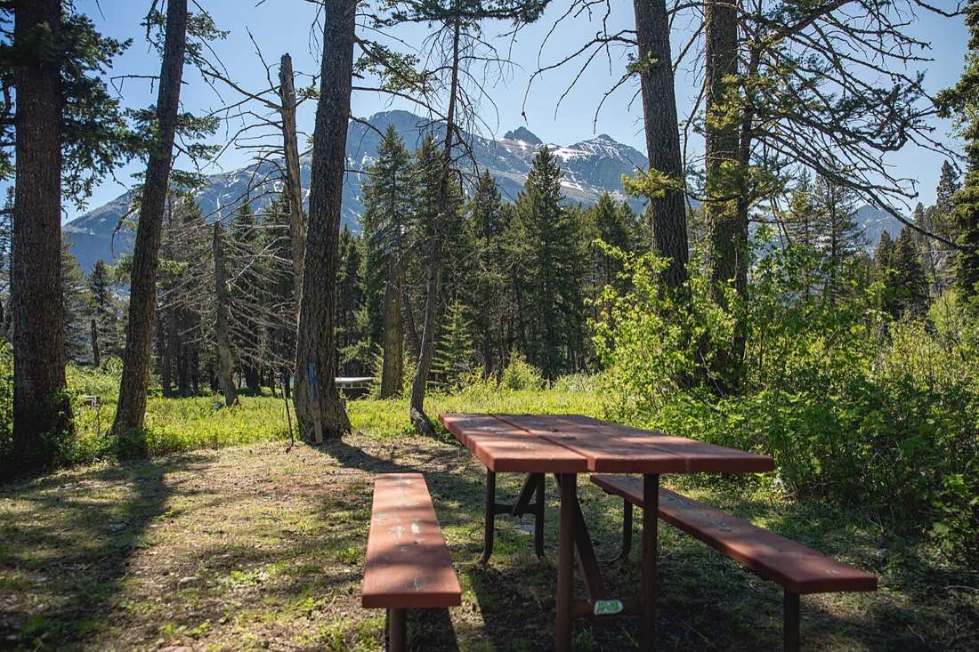 Tents in a campground below the mountains