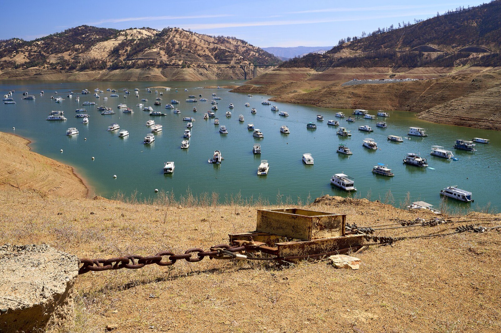 Boats moored far below the high water mark on a drawn down reservoir