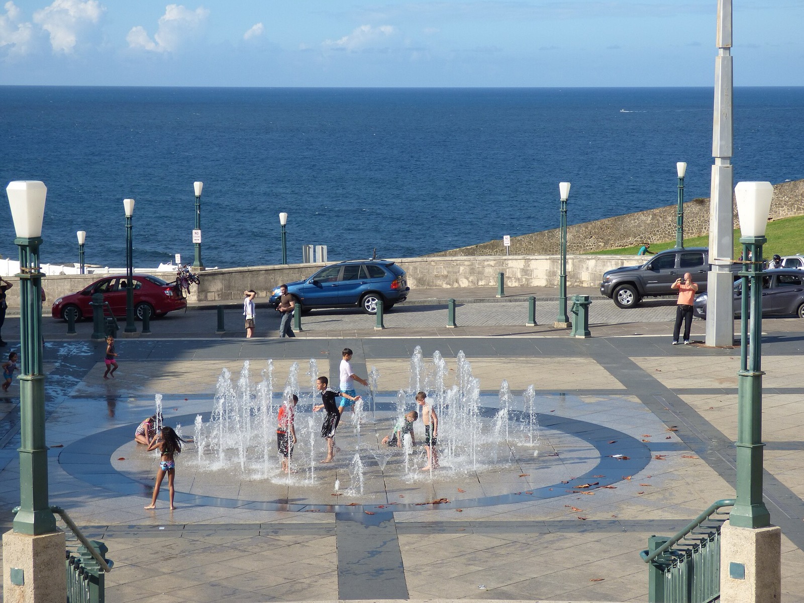 Children playing in a public plaza fountain beside the Atlantic in San Juan, Puerto Rico