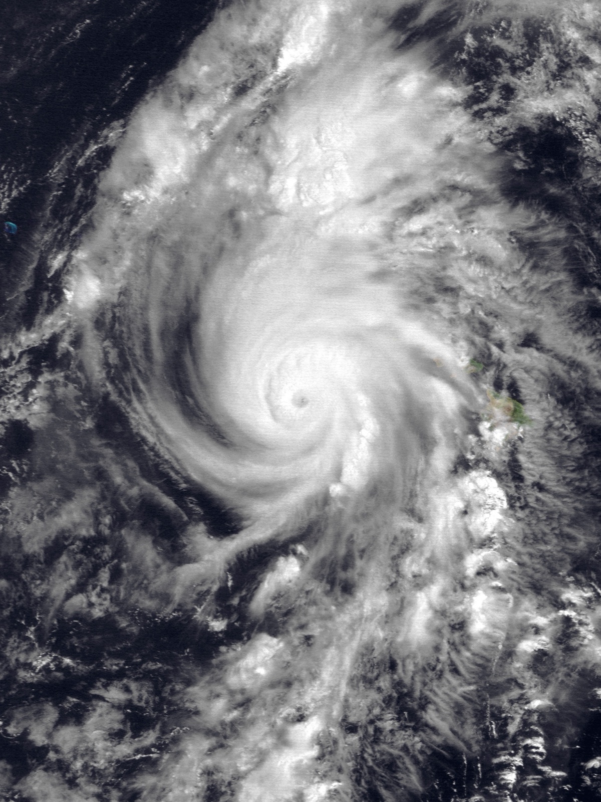 Satellite image of Hurricane Iniki, a compact hurricane with a clear eye, southwest of the Hawaiian Islands