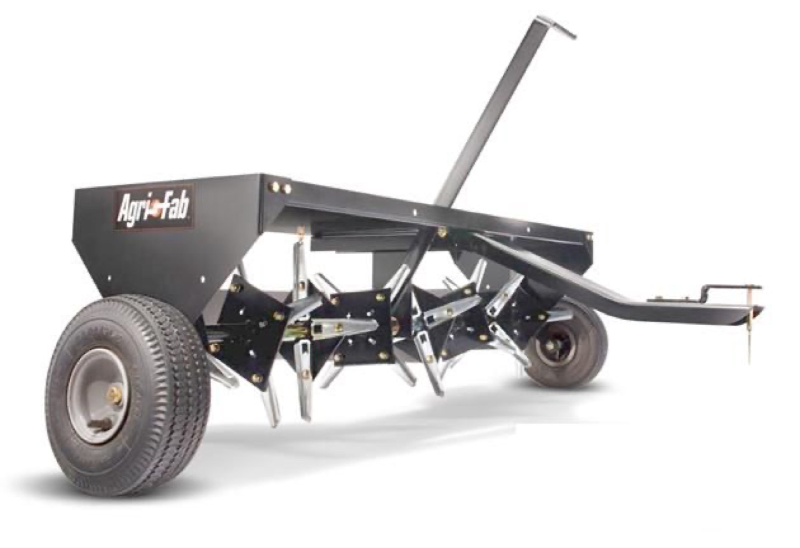 Tow-behind plug aerator pulling soil cores from a lawn