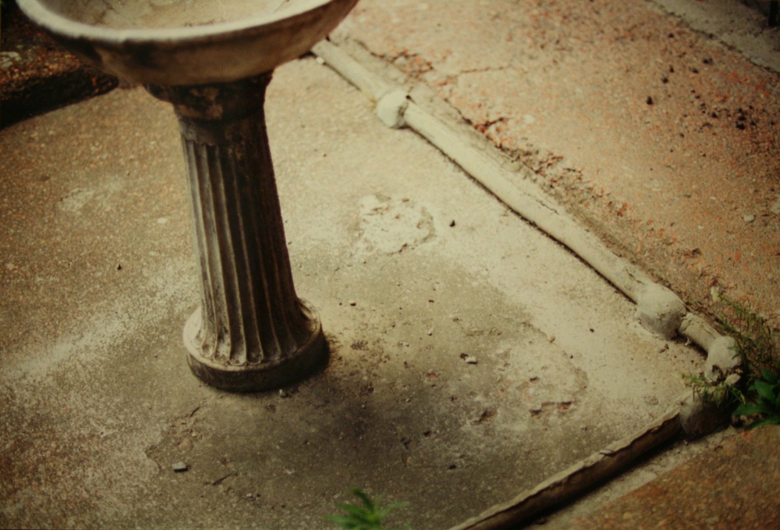 A Roman lead water pipe running along a courtyard floor at Pompeii