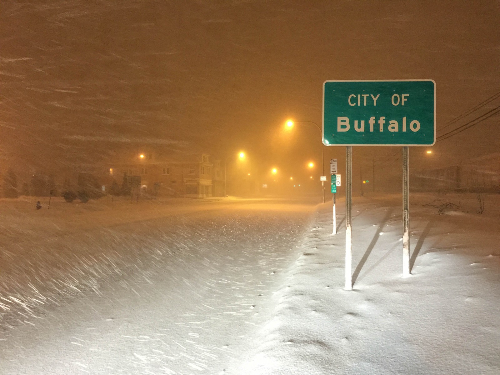 City of Buffalo boundary sign at night in wind driven lake effect snow