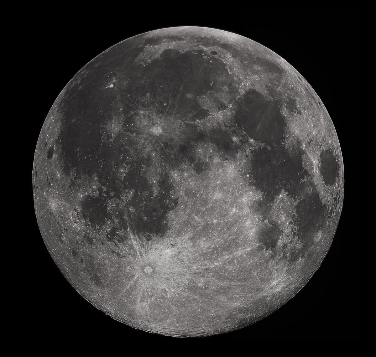 The full moon filling the frame, gray and cratered on a black sky, with the dark maria and bright rays visible