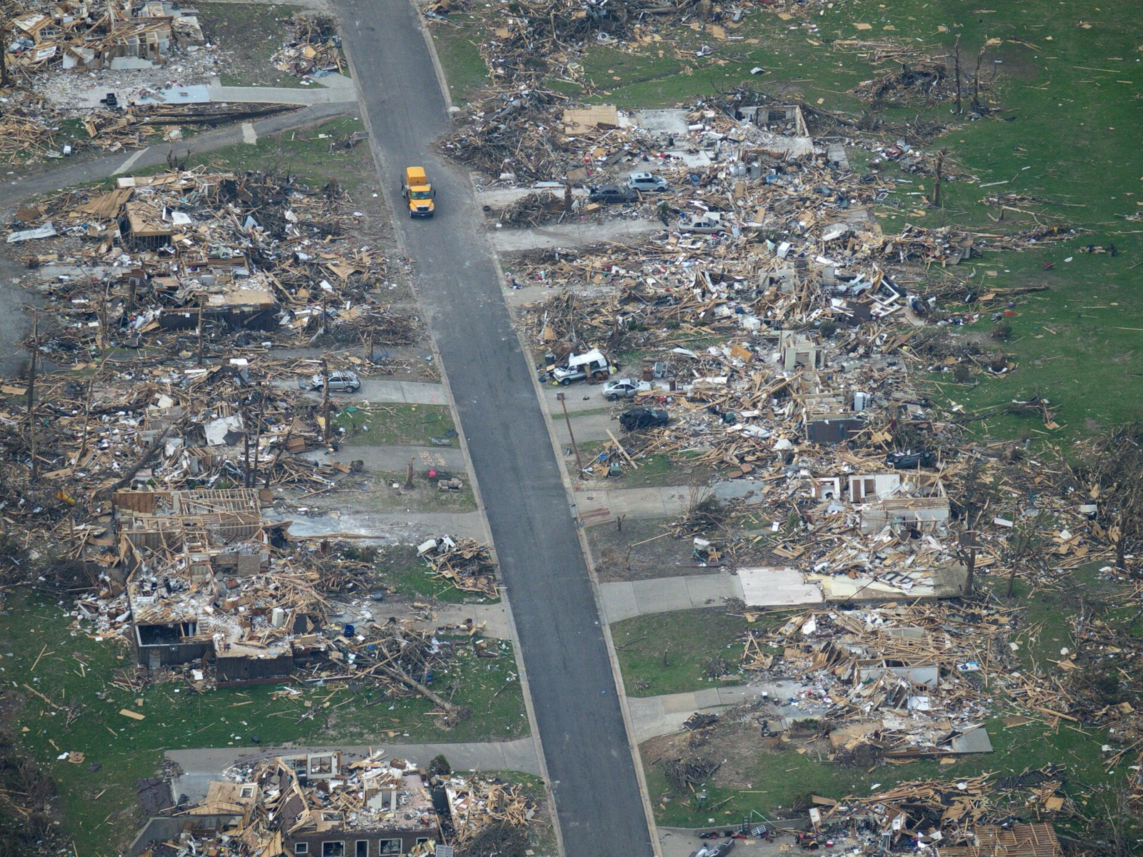 An aerial view of a Joplin, Missouri neighbourhood ten days after the 2011 EF5 tornado, block after block of houses reduced to bare slabs and splintered wood along an intact street grid