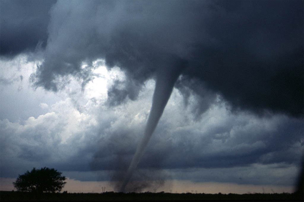 A classic cone shaped tornado with a debris cloud at its base, photographed near Anadarko, Oklahoma during the May 3, 1999 outbreak