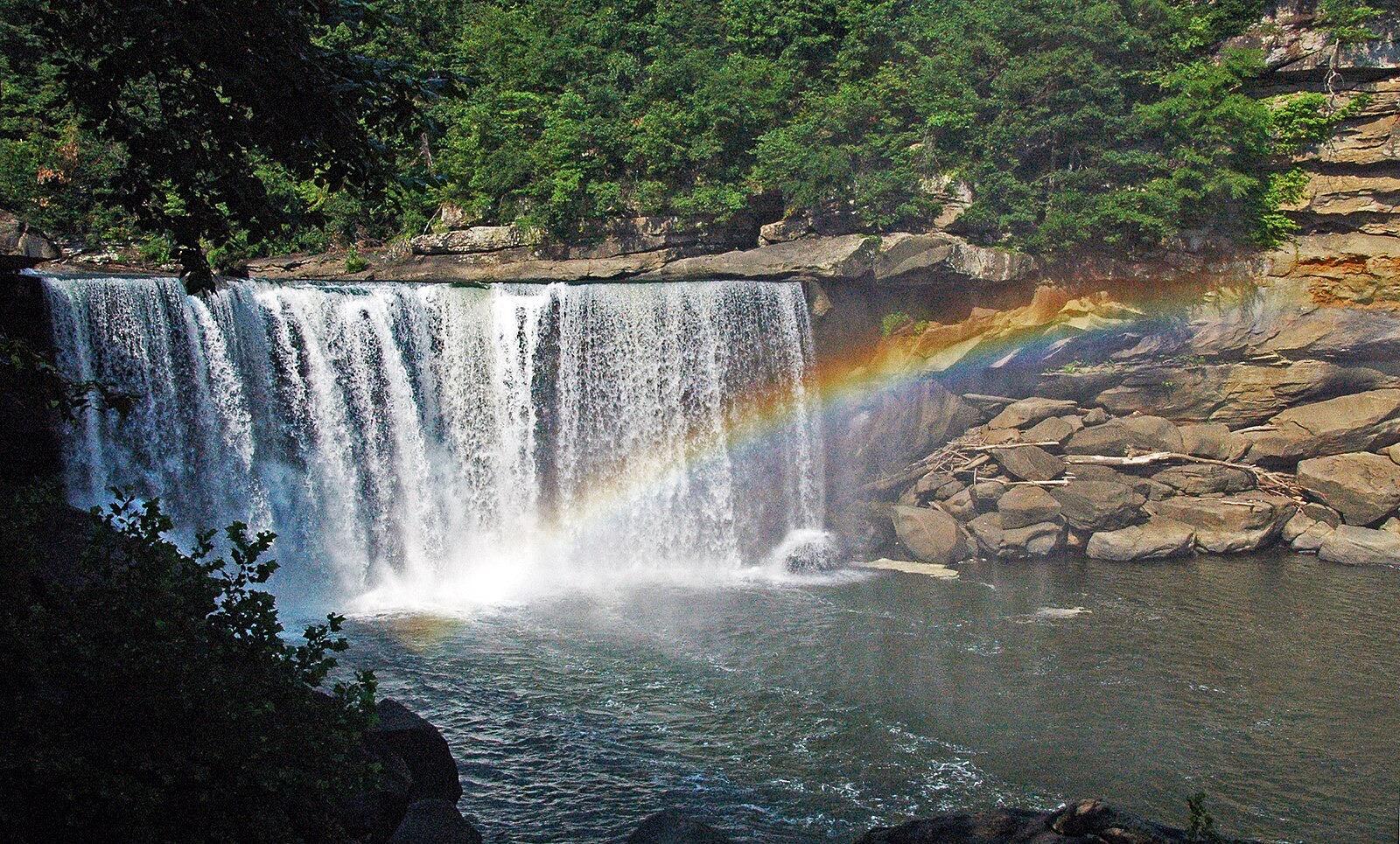 A wide southern waterfall dropping into a boulder-strewn gorge